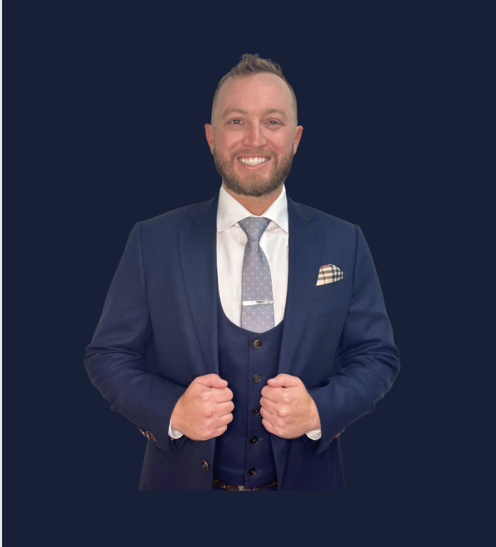 Alan Degen smiling in a navy suit